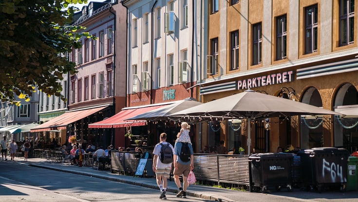 Gadebillede med caféer og farverige bygninger